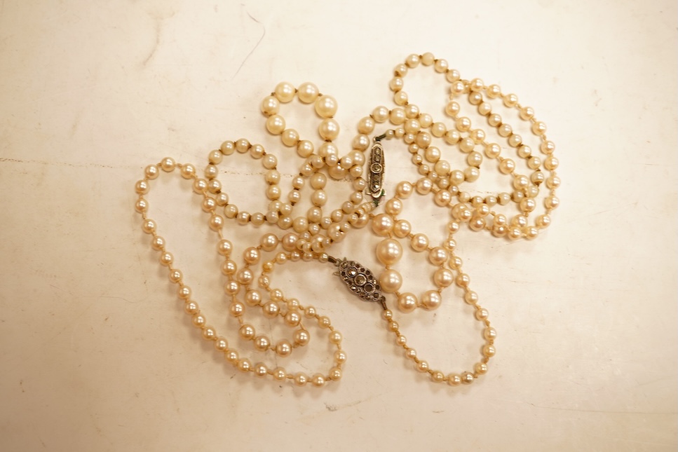 Two single strands graduated cultured pearl necklaces, both with marcasite set sterling clasps, longest, 64cm.